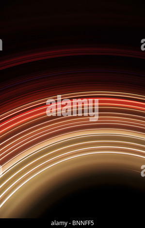 Abstract background of glowing stripes of streaks of light bands in a form of several lines on black background. Long Exposure. Stock Photo
