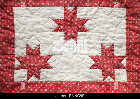 three eight-point quilted stars with a border Stock Photo