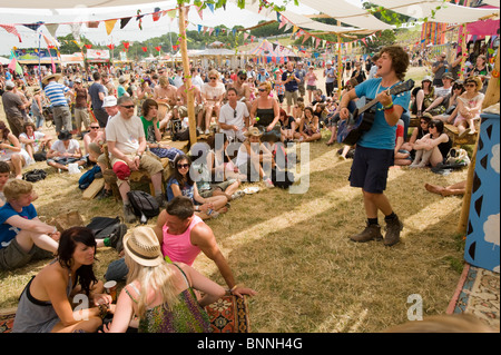 Impromptu low key entertainment in the Park area of the Glastonbury Festival, Somerset, UK. Stock Photo