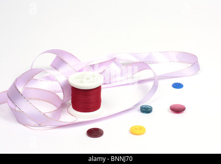 Threads with colored buttons and a pink tape Stock Photo