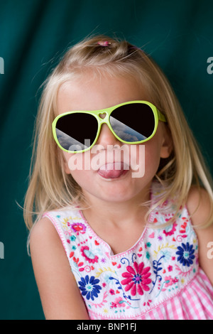 Young girl poking her tongue out. Stock Photo