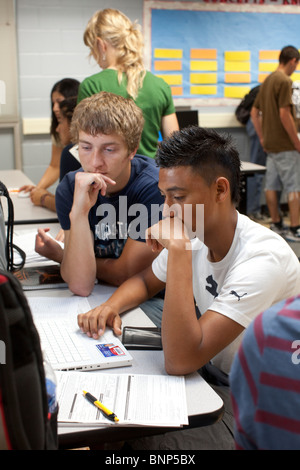 Hispanic, Anglo boys work on computer together doing research for class project at Manor New Tech High School in Manor, Texas Stock Photo