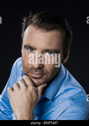 caucasian man unshaven portrait smiling cheerful isolated studio on black background Stock Photo