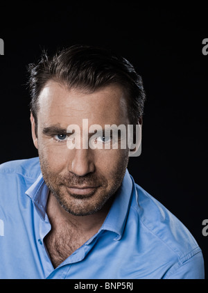 caucasian man unshaven portrait smiling cheerful isolated studio on black background Stock Photo