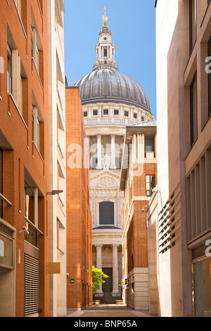 View of St Paul's cathedral from between neighbouring buildings in London.