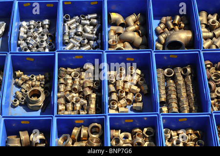 plumbing bronze brass pieces stuff in blue shop boxes Stock Photo