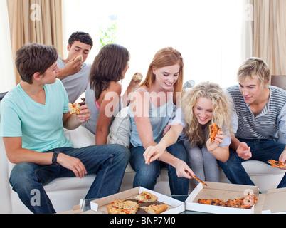 Teenagers eating pizza at home Stock Photo