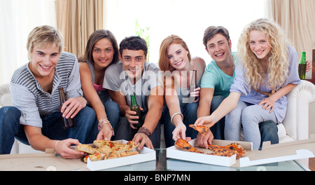 Friends eating pizza at home Stock Photo