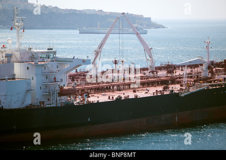 The Decks of two Oil tankers anchored  alongside each other doing 'ship to ship' cargo transfer. Gibraltar. Lightening one ship into the other Stock Photo