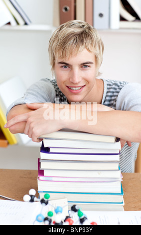 Tired teeenager sleeping in a library Stock Photo