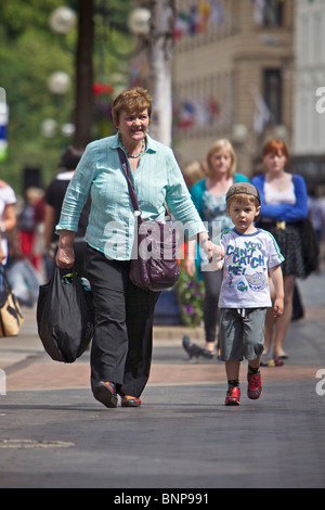 Active pensioners on busy shopping street Stock Photo