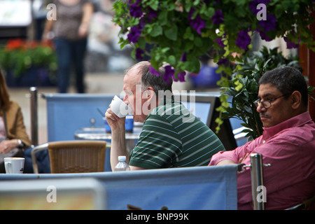 Active pensioners on busy shopping street Stock Photo