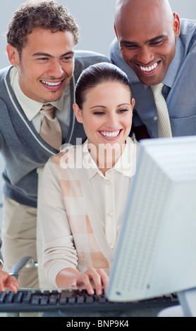 Attractive businesswoman and her colleagues working at a computer Stock Photo