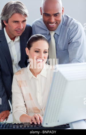 Assertive business people working at a computer Stock Photo