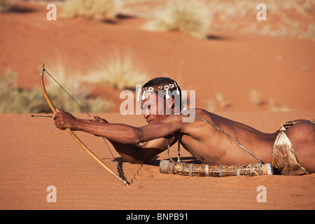 Bushman/San People. Male San hunter armed with traditional bow and arrow. Stock Photo