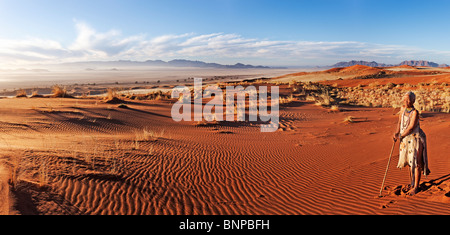 Elderly Bushman / San woman standing in desert Stock Photo