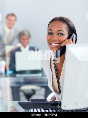 Beautiful businesswoman on phone at her desk Stock Photo