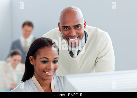Portrait of two  attractive businesspeople working at a computer Stock Photo