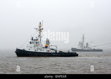 Two tugs in Emden outer harbor, Emden, Germany Stock Photo