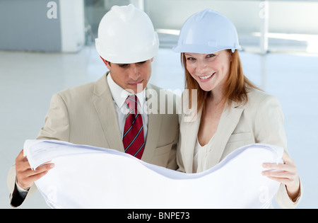 Two architects discussing a construction plan Stock Photo