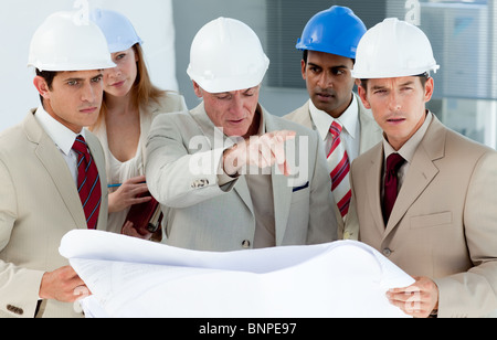 Engineers studying plans Stock Photo