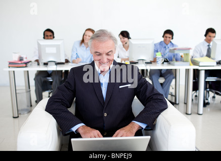 Senior businessman using a laptop Stock Photo