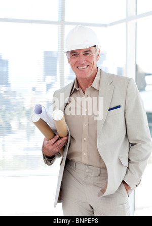 Senior architect with a hardhat holding blueprints Stock Photo