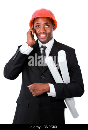 Young architect with blueprints communicating on a mobile Stock Photo