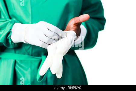 Surgeon putting on his gloves Stock Photo