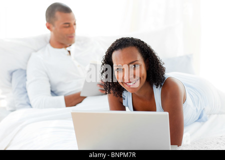 Affectionate couple relaxing on their bed Stock Photo