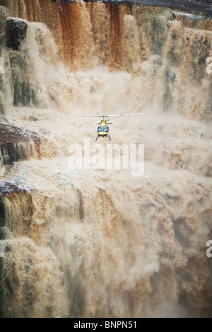 Tourists flying in helicopter exploring the Saikaka waterfall in Guyana South America Stock Photo