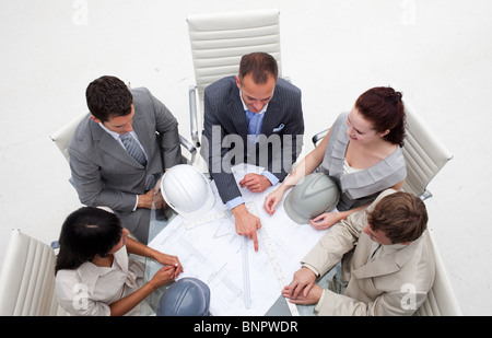 High angle of architects working with blueprints Stock Photo