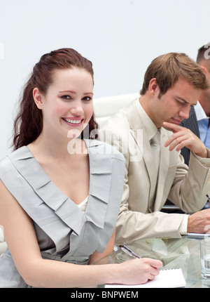 Charming businesswoman making notes Stock Photo