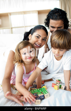 Portrait of a happy family playing with letter blocks Stock Photo