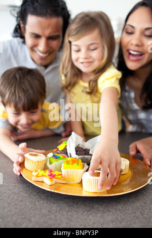 Joyful family eating cookies Stock Photo