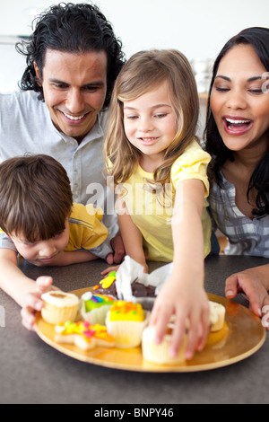 Jolly family eating cookies Stock Photo