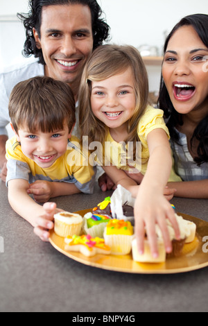 Lively family eating cookies Stock Photo