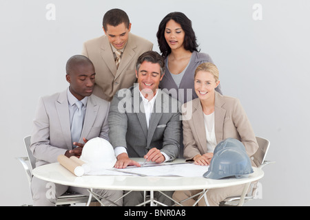 Architectural business people studying plans Stock Photo