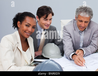 Female engineer studying plans in a meeting Stock Photo