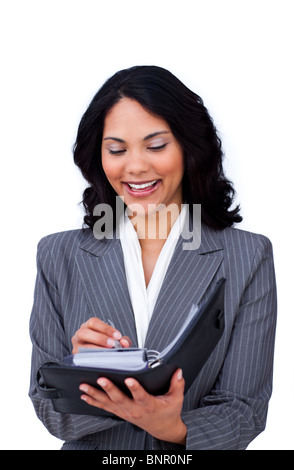 Businesswoman making notes on her agenda Stock Photo