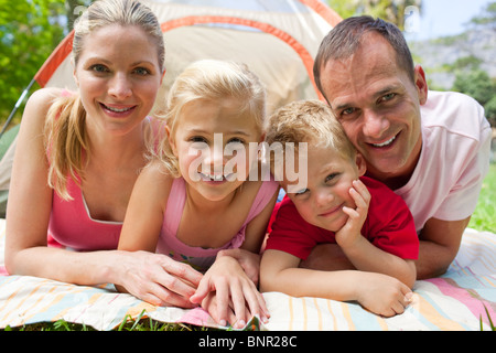 Portrait of a happy family lying on the grass Stock Photo
