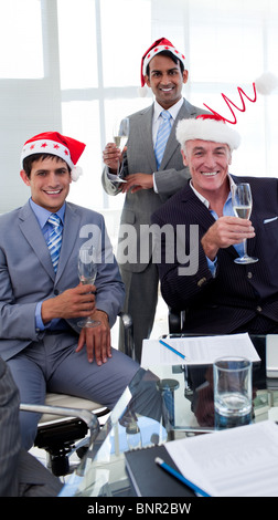 Confident businessmen wearing novelty Christmas hat Stock Photo