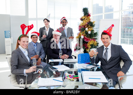 Portrait of a smiling business team wearing novelty Christmas hat Stock Photo
