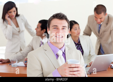 Cheerful manager drinking a coffee Stock Photo