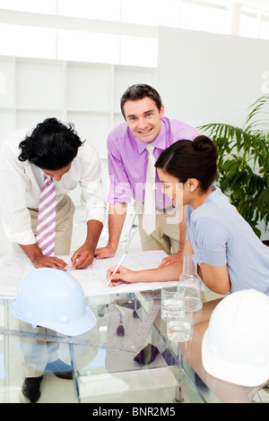 Architect co-workers reviewing blueprints Stock Photo