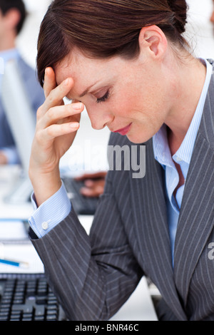Attractive businesswoman suffering from a migraine Stock Photo