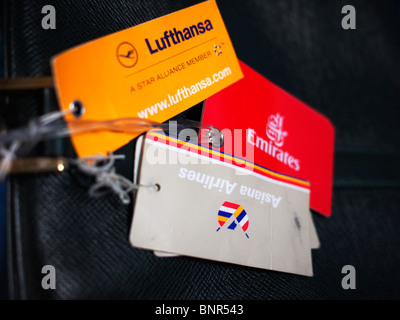 Passenger name tags bearing logos of different carriers Stock Photo