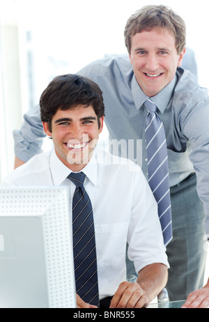 Two male executives working at a computer Stock Photo