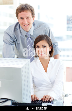 Confident manager helping his colleague Stock Photo