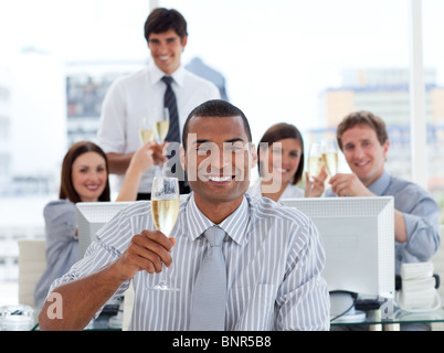 Lucky business team drinking champagne Stock Photo